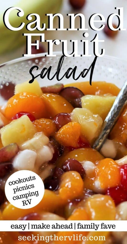Pinerest pin image of colorful canned fruit salad recipe in a bowl with peaches, grapes, pineapple, cherries, banana, and marshmallows.